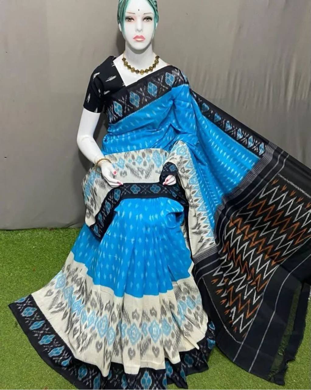 Blue and black saree with intricate patterns from Hooriya fashion saree collection displayed on mannequin