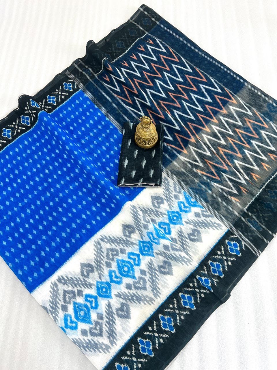 Blue and black saree with geometric patterns from Hooriya fashion saree collection displayed on white surface