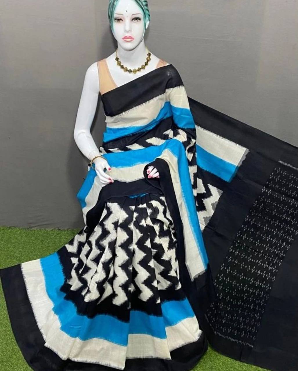 Premium linen traditional saree in black, white, and blue geometric patterns displayed on mannequin